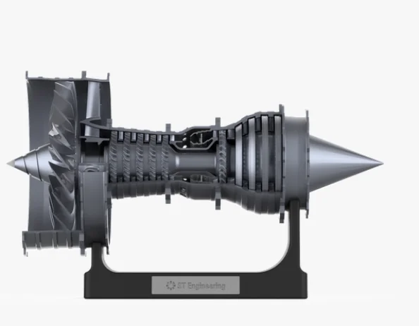 Early render of the grey cutaway engine side on, resting in a black cradle stand with a small ST Engineering plate