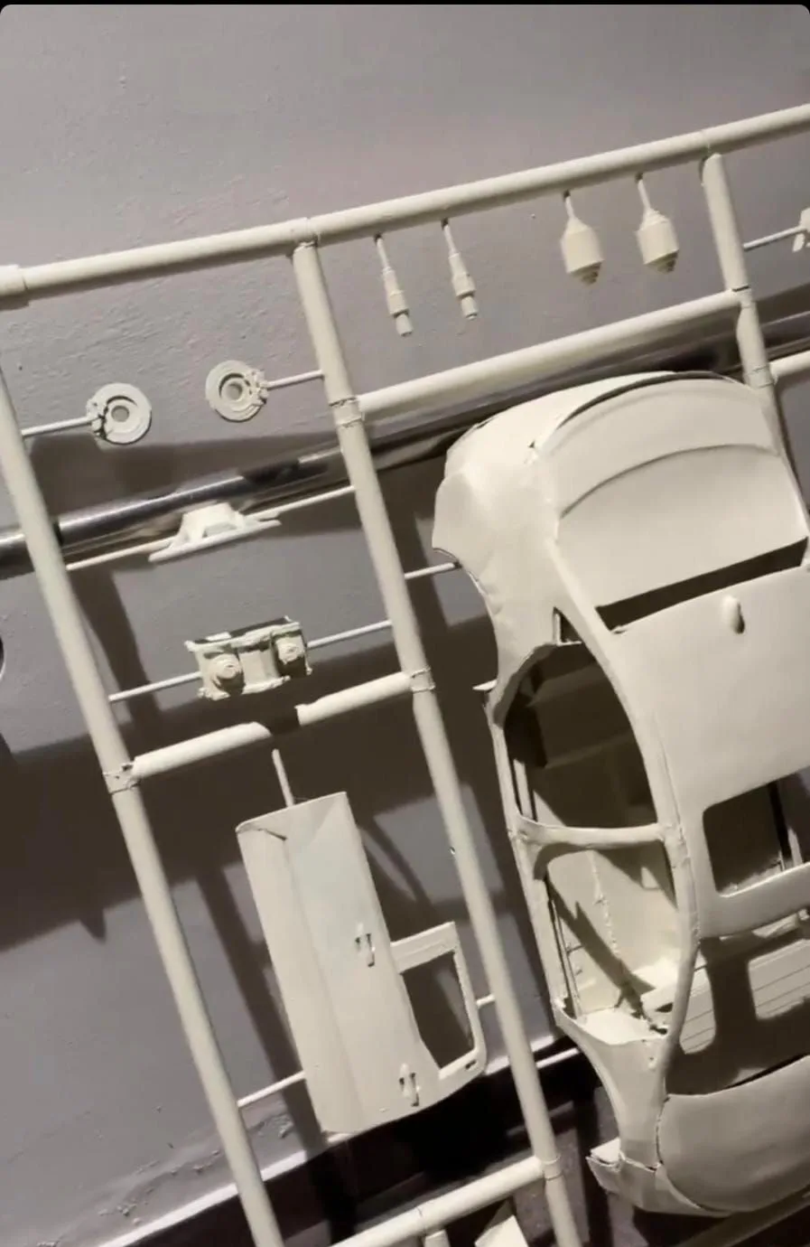 A sprayed car body and its parts mounted on the frame, seen close up