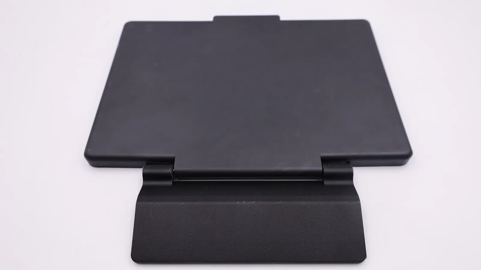 The finished black screen protector, front plate closed and joined by its hinge to the angled back plate that mounts on the unit