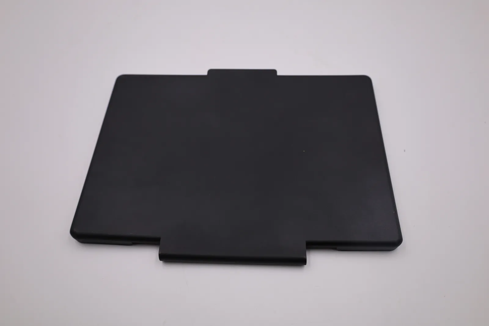 The outside face of a cast front plate, smooth matt black, with the hinge knuckle at the top and a finger tab at the bottom