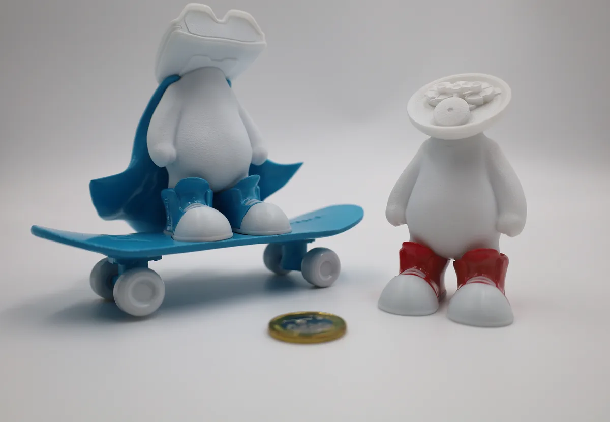 White character figurines, one riding a skateboard