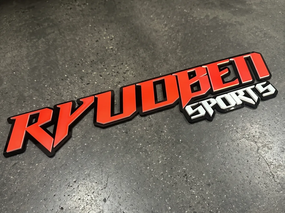 Red and silver dimensional Ryuoben Sports logo sign