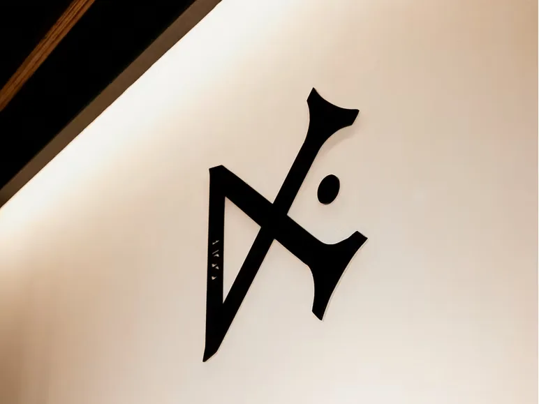 Black sculptural Avaday logo mounted on a boutique wall