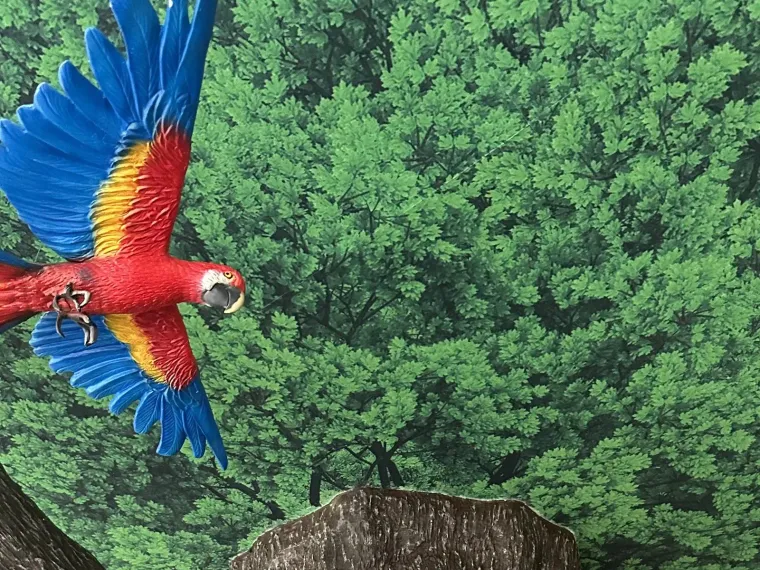 Hand-painted rainforest mural with sculpted tree pillar at Mandai Zoo kindergarten