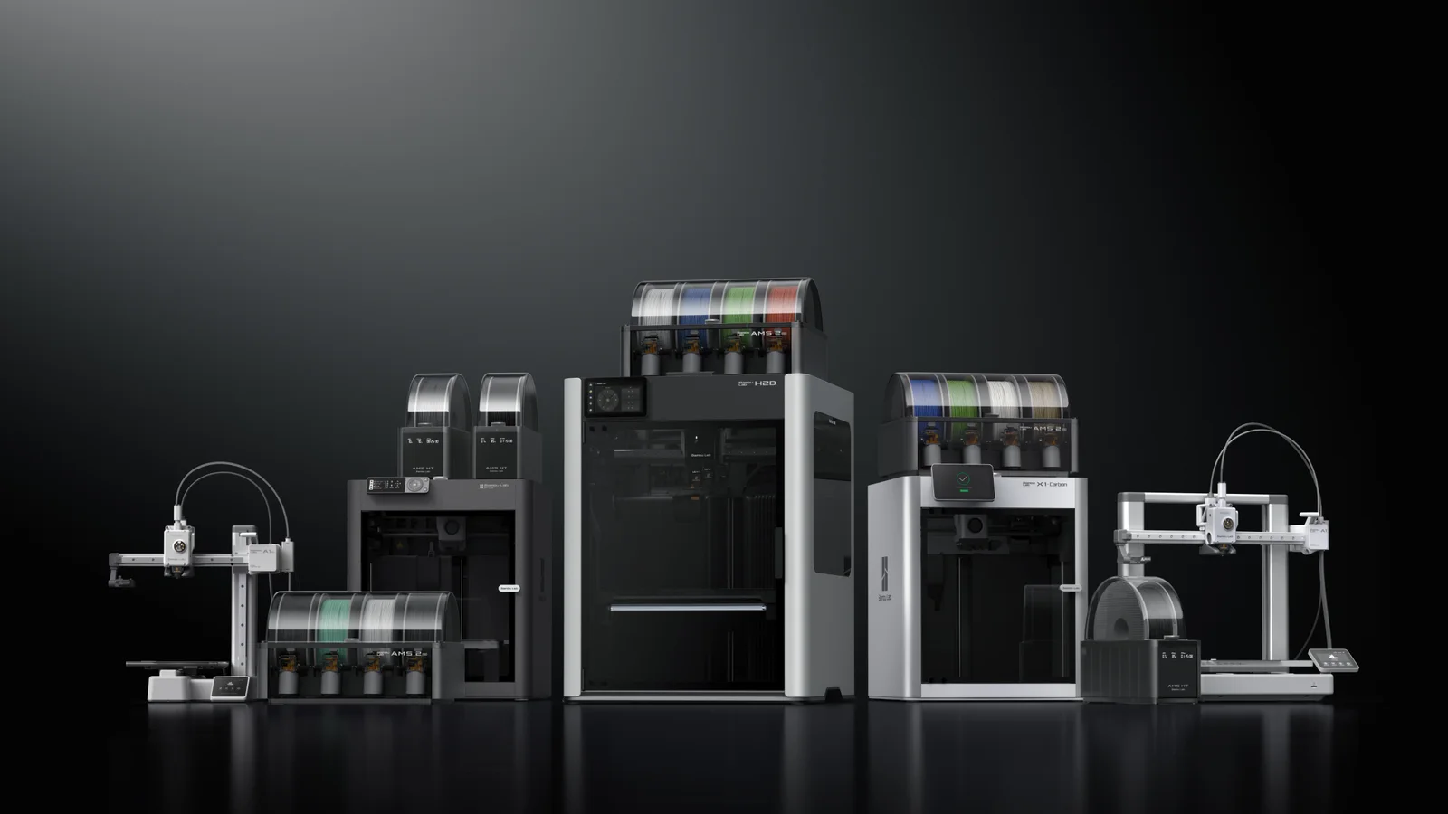 Bambu Lab printers with AMS 2 Pro and AMS HT units stacked on and beside them