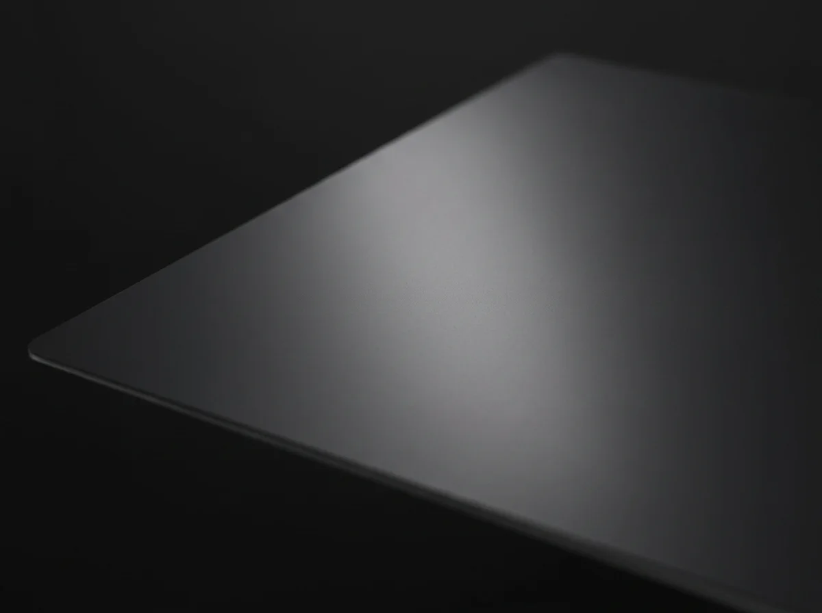 One broad soft highlight sweeping across the flat black smooth PEI surface.
