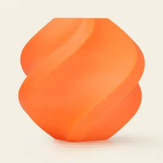 An orange vase 3D printed in ABS-GF filament, with a matte finish