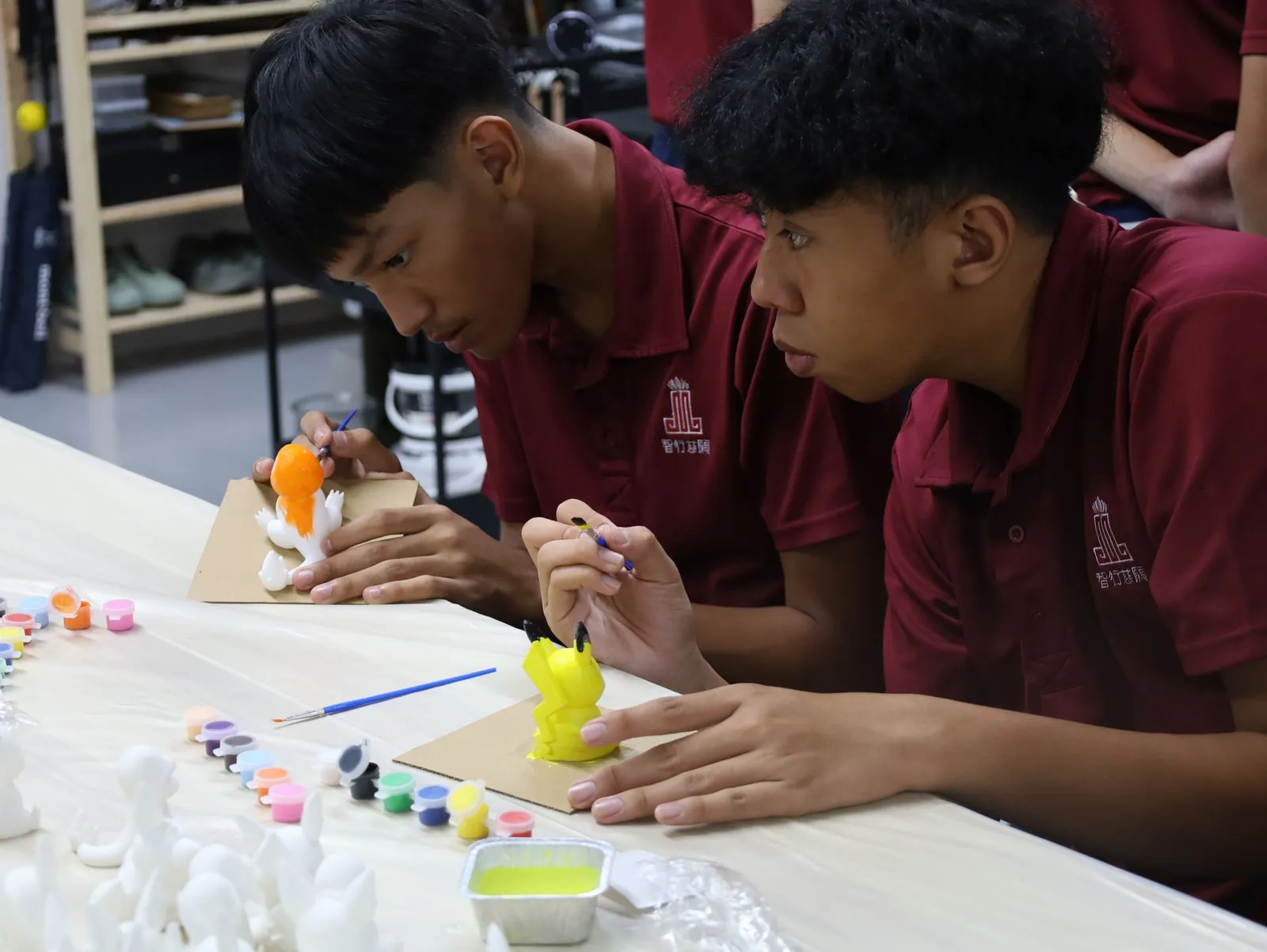 Students painting their figurines
